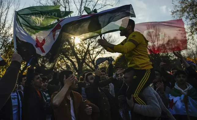 People gather to celebrate the Syrian government's fall in Istanbul, Turkey, on Sunday, Dec. 8, 2024. (AP Photo/Emrah Gurel)