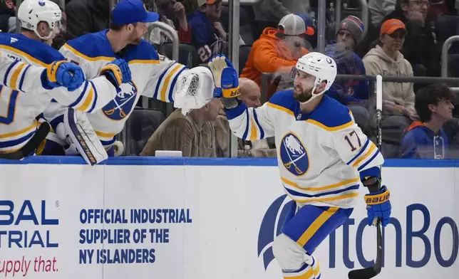 Buffalo Sabres' Jason Zucker (17) celebrates with teammates after scoring a goal during the second period of an NHL hockey game against the New York Islanders Monday, Dec. 23, 2024, in Elmont, N.Y. (AP Photo/Frank Franklin II)