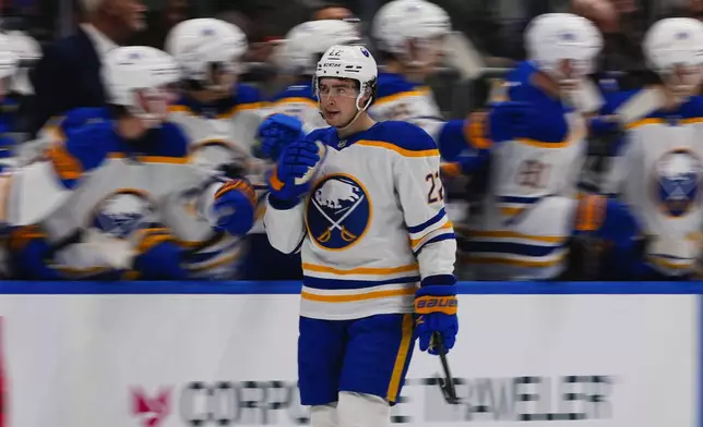 Buffalo Sabres' Jack Quinn (22) celebrates with teammates after scoring a goal during the second period of an NHL hockey game against the New York Islanders Monday, Dec. 23, 2024, in Elmont, N.Y. (AP Photo/Frank Franklin II)