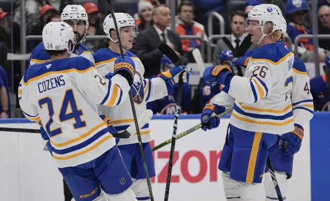 Buffalo Sabres' Jiri Kulich, center, celebrates with teammates after scoring a goal during the first period of an NHL hockey game against the New York Islanders Monday, Dec. 23, 2024, in Elmont, N.Y. (AP Photo/Frank Franklin II)