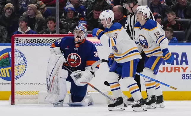 New York Islanders goaltender Ilya Sorokin (30) reacts as Buffalo Sabres' Peyton Krebs (19) and Zach Benson (9) skate past himo after Benson scored a goal during the second period of an NHL hockey game Monday, Dec. 23, 2024, in Elmont, N.Y. (AP Photo/Frank Franklin II)