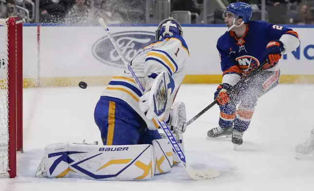 New York Islanders' Kyle Palmieri (21) shoots the puck past Buffalo Sabres goaltender Ukko-Pekka Luukkonen (1) for a goal during the second period of an NHL hockey game Monday, Dec. 23, 2024, in Elmont, N.Y. (AP Photo/Frank Franklin II)