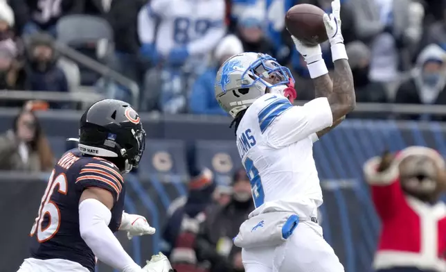 Detroit Lions wide receiver Jameson Williams catches an 82-yard touchdown pass from quarterback Jared Goff as Chicago Bears safety Jonathan Owens defends during the first half of an NFL football game Sunday, Dec. 22, 2024, in Chicago. (AP Photo/Nam Y. Huh)