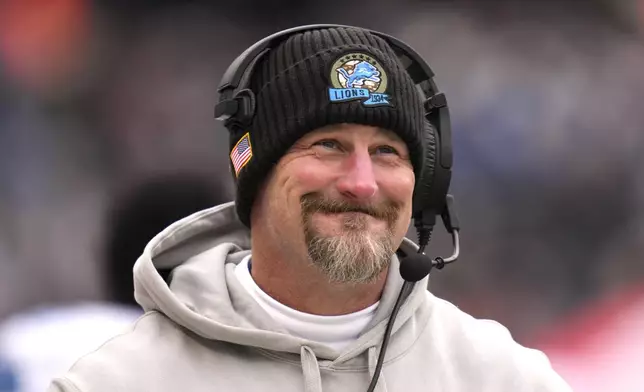 Detroit Lions head coach Dan Campbell smiles along the sidelines during the first half of an NFL football game against the Chicago Bears on Sunday, Dec. 22, 2024, in Chicago. (AP Photo/Erin Hooley)