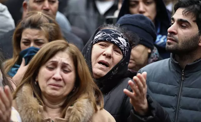 People mourn during a funeral of the crew members of the Azerbaijan Airlines Embraer 190 killed in a deadly plane crash in Kazakhstan this week, at the II Alley of Honor in Baku, Azerbaijan, Sunday, Dec. 29, 2024. (AP photo)