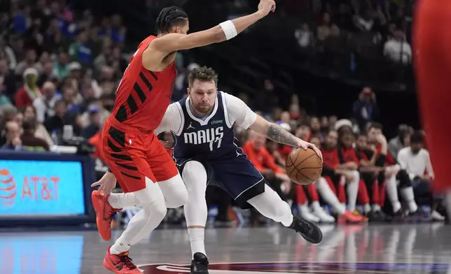 Dallas Mavericks guard Luka Doncic drives against Portland Trail Blazers forward Toumani Camara during the second half of an NBA basketball game, Monday, Dec. 23, 2024, in Dallas. (AP Photo/LM Otero)