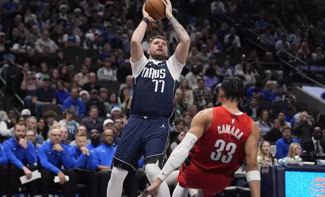 Dallas Mavericks guard Luka Doncic (77) shoots against Portland Trail Blazers forward Toumani Camara (33) during the second half of an NBA basketball game, Monday, Dec. 23, 2024, in Dallas. (AP Photo/LM Otero)