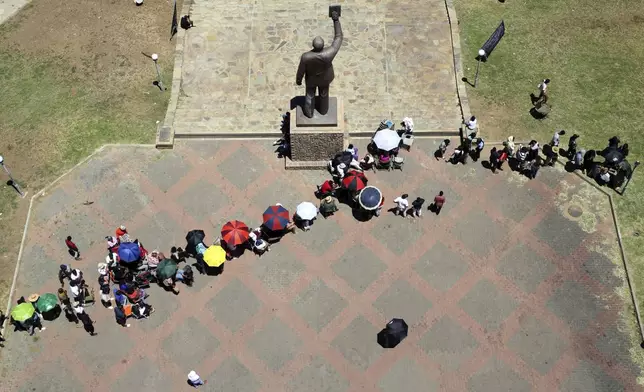 Namibians queue to cast their votes in presidential elections in Windhoek, Namibia, Wednesday, Nov. 27, 2024. (AP Photo/Dirk Heinrich)