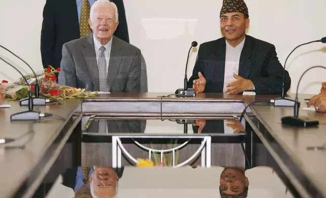 FILE - Former U.S. President Jimmy Carter meets with Bhoj Raj Pokhrel, Nepal's chief election official, on April 8, 2008, in Katmandu, Nepal. (AP Photo/Ed Wray, File)