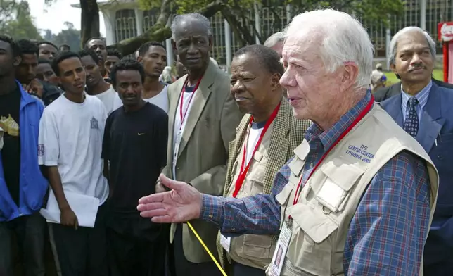 FILE - Former U.S. President Jimmy Carter, right, former Botswanan President Ketumile Joni Masire, center, and former Tanzanian Prime Minister Joseph Warioba, fourth from right, address members of the media at a polling station at the university in Addis Ababa, during the third democratic elections in Ethiopia's 3,000-year history, May 15, 2005. (AP Photo/Karel Prinsloo, File)