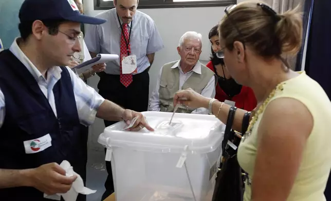 FILE - Former U.S. President Jimmy Carter, center, monitors voting at a polling station in Beirut's Christian sector of Ashrafieh, Lebanon, on June 7, 2009. (AP Photo/Hussein Malla, File)