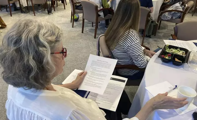 FILE - A volunteer election observer reviews training materials on Nov. 6, 2022, at the Carter Center in Atlanta. (AP Photo/Jeff Amy, File)