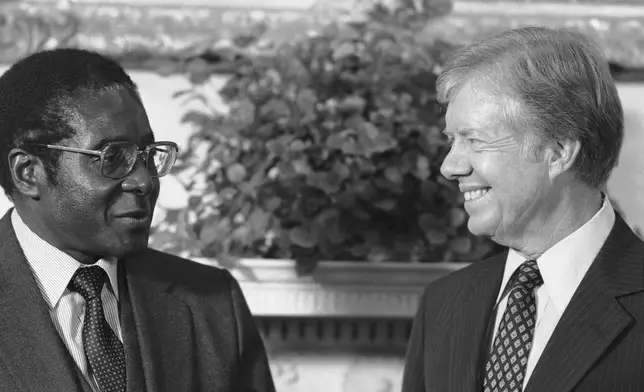 FILE - President Jimmy Carter meets with Zimbabwe Prime Minister Robert Mugabe in the Oval Office in Washington, on Aug. 27, 1980. (AP Photo/Barry Thumma, File)