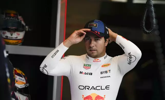 Red Bull driver Sergio Perez of Mexico arrives for the practice ahead of the Formula One Abu Dhabi Grand Prix at the Yas Marina Circuit in Abu Dhabi, UAE, Friday, Dec. 6, 2024. (AP Photo/Altaf Qadri)