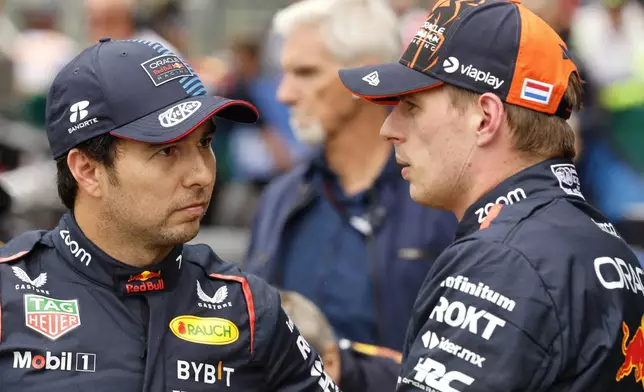 FILE- Red Bull driver Max Verstappen of the Netherlands, right, who clocked the fastest time, speaks with Red Bull driver Sergio Perez of Mexico , who clocked the third fastest time during qualification ahead of the Formula One Grand Prix at the Spa-Francorchamps racetrack in Spa, Belgium, Saturday, July 27, 2024. (AP Photo/Geert Vanden Wijngaert, File0