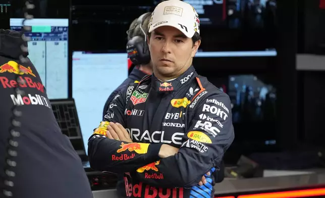 FILE - Red Bull driver Sergio Perez, of Mexico, waits in the garage area prior to a practice session for the Formula One U.S. Grand Prix auto race, Thursday, Nov. 21, 2024, in Las Vegas. (AP Photo/Matt York, File)