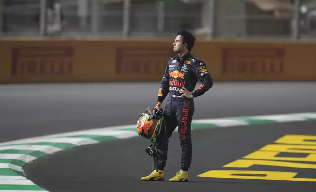 FILE - Red Bull driver Sergio Perez of Mexico waits for the safety car after race was stopped during the Formula One Saudi Arabian Grand Prix in Jiddah, Sunday, Dec. 5, 2021. (AP Photo/Hassan Ammar, File)