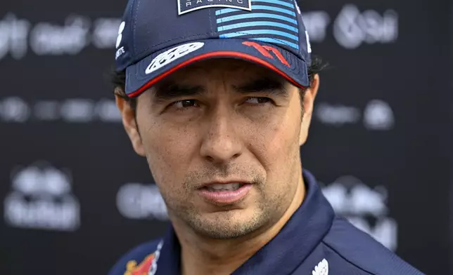 FILE - Red Bull driver Sergio Perez of Mexico arrives in the paddock before of the third free practice ahead of Sunday's Formula One Hungarian Grand Prix auto race, at the Hungaroring racetrack in Mogyorod, near Budapest, Hungary, Saturday, July 20, 2024. (AP Photo/Denes Erdos, File)