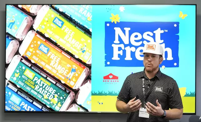 NestFresh executive vice president Jasen Urena speaks about the CHEGGY machine, an SUV-sized machine that can separate eggs by sex, before a demonstration at the Hy-Line hatchery, Tuesday, Dec. 10, 2024, in Wilton, Iowa. (AP Photo/Charlie Neibergall)