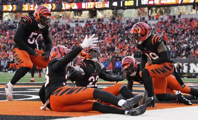 Cincinnati Bengals safety Geno Stone (22) celebrates with teammates after an interception during the second half of an NFL football game against the Cleveland Browns, Sunday, Dec. 22, 2024, in Cincinnati. (AP Photo/Jeff Dean)