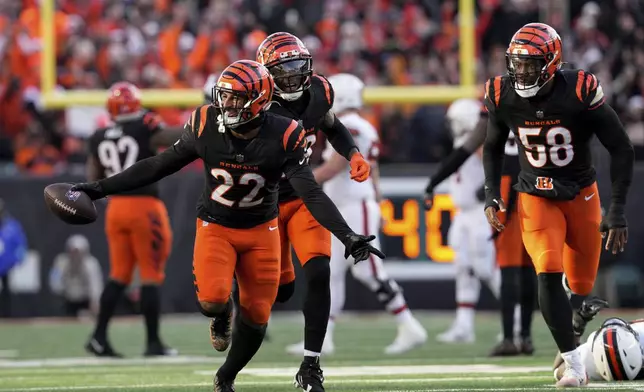 Cincinnati Bengals safety Geno Stone (22) celebrates with teammates after an interception during the second half of an NFL football game against the Cleveland Browns, Sunday, Dec. 22, 2024, in Cincinnati. (AP Photo/Jeff Dean)