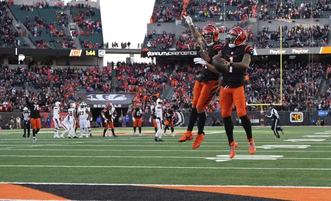 Cincinnati Bengals wide receiver Ja'Marr Chase (1) celebrates with Cincinnati Bengals wide receiver Jermaine Burton (81) after making a touchdown catch during the second half of an NFL football game against the Cleveland Browns, Sunday, Dec. 22, 2024, in Cincinnati. (AP Photo/Jeff Dean)