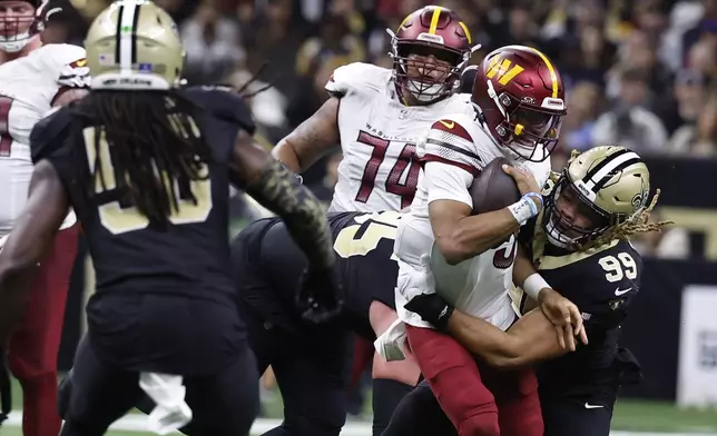 New Orleans Saints defensive end Chase Young (99) sacks Washington Commanders quarterback Jayden Daniels (5) in the second half of an NFL football game in New Orleans, Sunday, Dec. 15, 2024. (AP Photo/Butch Dill)