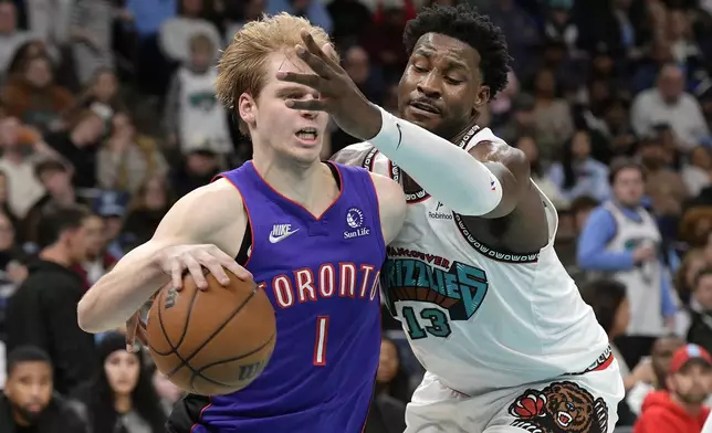 Toronto Raptors guard Gradey Dick (1) drives against Memphis Grizzlies forward Jaren Jackson Jr. (13) in the first half of an NBA basketball game Thursday, Dec. 26, 2024, in Memphis, Tenn. (AP Photo/Brandon Dill)