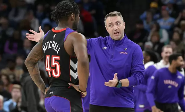 Toronto Raptors head coach Darko Rajakovic, right, talks with guard Davion Mitchell (45) in the first half of an NBA basketball game against the Memphis Grizzlies, Thursday, Dec. 26, 2024, in Memphis, Tenn. (AP Photo/Brandon Dill)