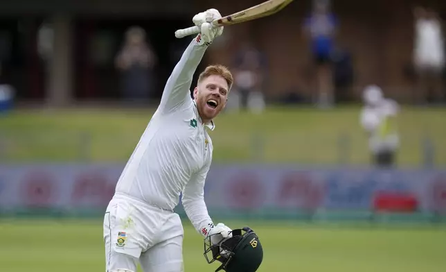 South Africa's Kyle Verreynne celebrates after scoring a century during the second day of the second test cricket match between South Africa and Sri Lanka, at St George's Park in Gqeberha, South Africa, Friday, Dec. 6, 2024. (AP Photo/Themba Hadebe)