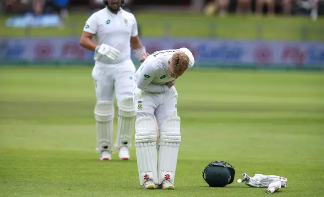 South Africa's Kyle Verreynne takes a bow in front of the players pavilion after scoring a century during the second day of the second test cricket match between South Africa and Sri Lanka, at St George's Park in Gqeberha, South Africa, Friday, Dec. 6, 2024. (AP Photo/Themba Hadebe)