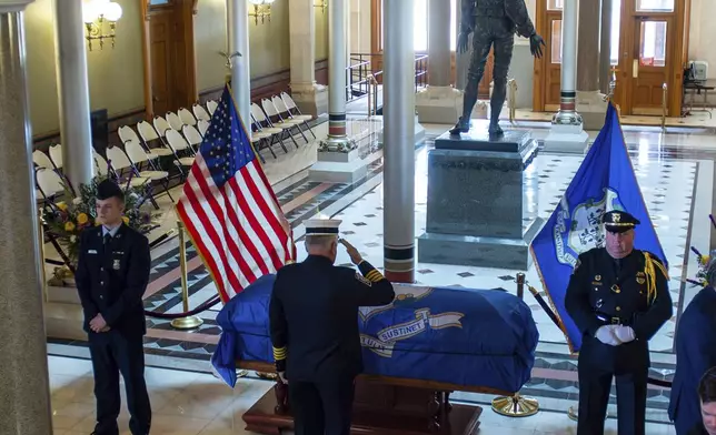 Simsbury Volunteer Fire Company Deputy Chief Kevin Kowalski pays his respects to former Governor M. Jodi Rell as she lays in state at the Connecticut State Capitol in Hartford, Conn., Tuesday, Dec. 3, 2024. (Aaron Flaum/Hartford Courant via AP)