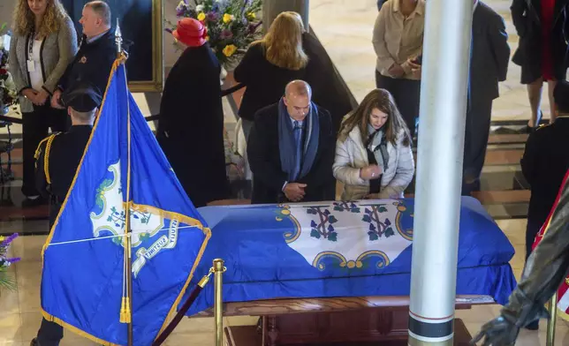 Mourners pay their respects to the former Governor M. Jodi Rell as she lays in state at the Connecticut State Capitol in Hartford, Conn., Tuesday, Dec. 3, 2024. (Aaron Flaum/Hartford Courant via AP)