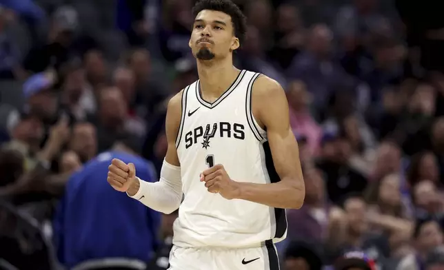 San Antonio Spurs center Victor Wembanyama (1) celebrates after defeating the Sacramento Kings in an NBA basketball game in Sacramento, Calif., Sunday, Dec. 1, 2024. (AP Photo/Jed Jacobsohn)