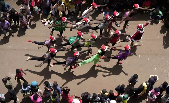 Young dancers perform, during a Christmas ballet event in Kibera slum, one of the busiest neighborhoods of Kenya's capital, Nairobi, Kenya Saturday, Dec. 21, 2024. (AP Photo/Brian Inganga)