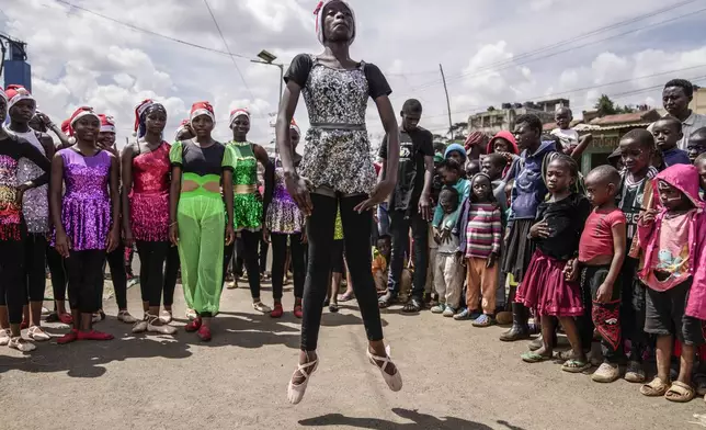 Young dancers perform, during a Christmas ballet event in Kibera slum, one of the busiest neighborhoods of Kenya's capital, Nairobi, Kenya Saturday, Dec. 21, 2024. (AP Photo/Brian Inganga)