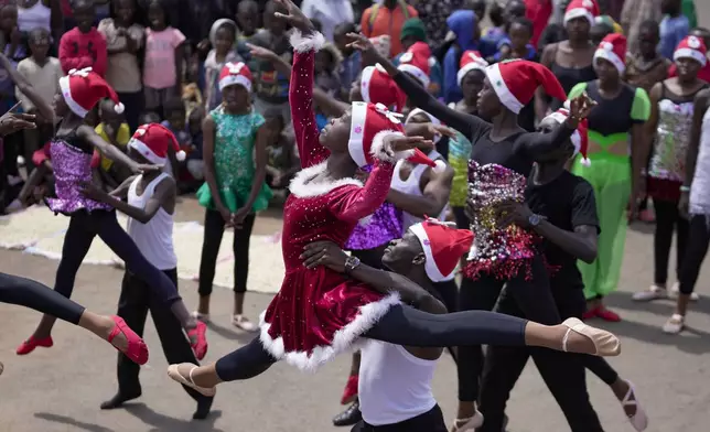 Young dancers perform, during a Christmas ballet event in Kibera slum, one of the busiest neighborhoods of Kenya's capital, Nairobi, Kenya Saturday, Dec. 21, 2024. (AP Photo/Brian Inganga)