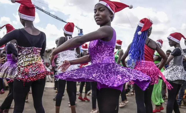 Young dancers perform, during a Christmas ballet event in Kibera slum, one of the busiest neighborhoods of Kenya's capital, Nairobi, Kenya Saturday, Dec. 21, 2024. (AP Photo/Brian Inganga)