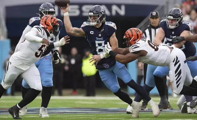 Tennessee Titans quarterback Will Levis (8) throws a pass while being pressured by Cincinnati Bengals defensive end Joseph Ossai, left, and defensive tackle Kris Jenkins Jr., right, during the first half of an NFL football game Sunday, Dec. 15, 2024, in Nashville, Tenn. (AP Photo/George Walker IV)