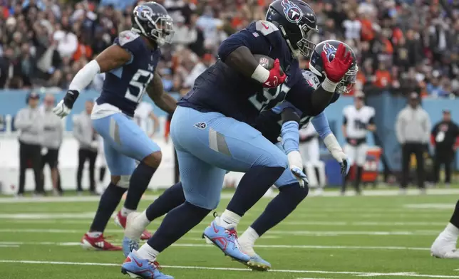 Tennessee Titans defensive tackle T'Vondre Sweat (93) runs with the ball after recovering a Cincinnati Bengals fumble during the first half of an NFL football game Sunday, Dec. 15, 2024, in Nashville, Tenn. (AP Photo/George Walker IV)