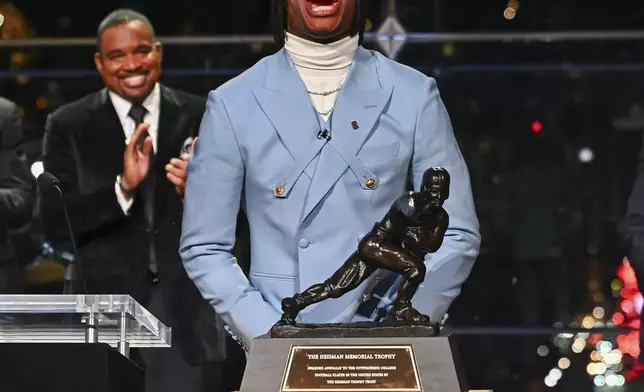 Colorado’s Travis Hunter reacts after winning the Heisman Trophy as the outstanding player in college football, Saturday, Dec. 14, 2024, in New York.(Todd Van Emst/Heisman Trust via AP, Pool)