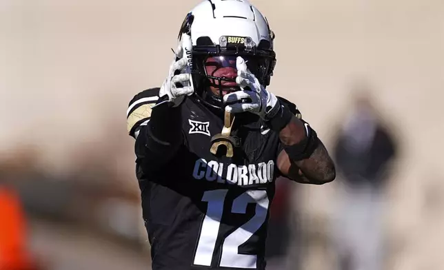 FILE - Colorado wide receiver Travis Hunter (12) reacts in the second half of an NCAA college football game Friday, Nov. 29, 2024, in Boulder, Colo. (AP Photo/David Zalubowski, File)