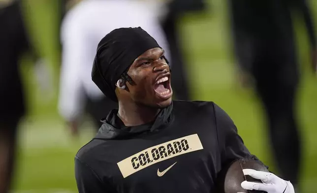 FILE - Colorado wide receiver Travis Hunter (12) reacts as he warms up before an NCAA college football game against Saturday, Oct. 12, 2024, in Boulder, Colo. (AP Photo/David Zalubowski, File)