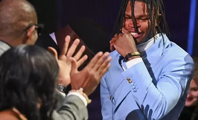 Colorado’s Travis Hunter reacts after winning the Heisman Trophy as the outstanding player in college football, Saturday, Dec. 14, 2024, in New York. (Todd Van Emst/Heisman Trust via AP, Pool)