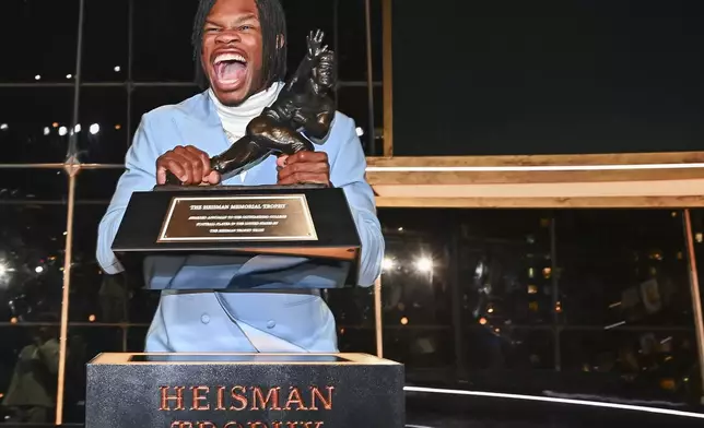 Colorado’s Travis Hunter poses with the trophy after winning the Heisman Trophy as the outstanding player in college football, Saturday, Dec. 14, 2024, in New York.(Todd Van Emst/Heisman Trust via AP, Pool)