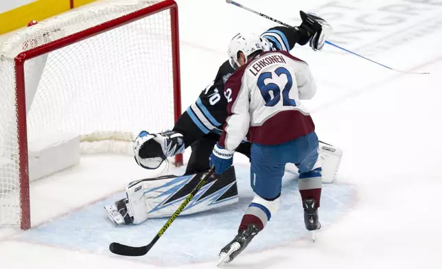 Colorado Avalanche left wing Artturi Lehkonen (62) gets the puck past Utah Hockey Club goaltender Karel Vejmelka (70) to score a goal during the third period of an NHL hockey game Friday, Dec. 27, 2024, in Salt Lake City. (AP Photo/Rick Egan)