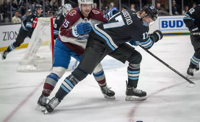 Colorado Avalanche right wing Logan O'Connor (25) gets tangled up with Utah Hockey Club center Nick Bjugstad (17) during the second period of an NHL hockey game Friday, Dec. 27, 2024, in Salt Lake City. (AP Photo/Rick Egan)