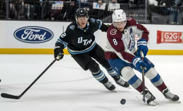 Utah Hockey Club defenseman Olli Maatta (2) defends as Colorado Avalanche defenseman Cale Makar (8) looks for a shot during the Second period of an NHL hockey game Friday, Dec. 27, 2024, in Salt Lake City. (AP Photo/Rick Egan)