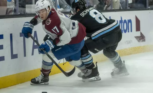 Utah Hockey Club center Nick Schmaltz (8) collides with Colorado Avalanche center Parker Kelly (17) during the first period of an NHL hockey game Friday, Dec. 27, 2024, in Salt Lake City. (AP Photo/Rick Egan)