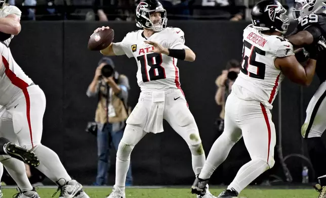 Atlanta Falcons quarterback Kirk Cousins (18) throws against the Las Vegas Raiders during the second half of an NFL football game, Monday, Dec. 16, 2024, in Las Vegas. (AP Photo/David Becker)